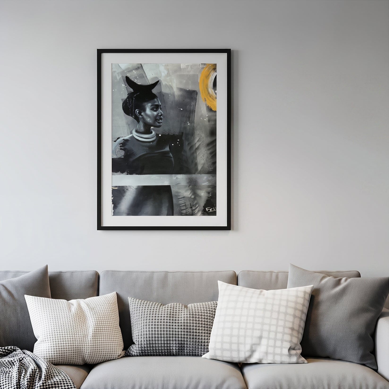 My footprints by feli the artist is A framed art print featuring an abstract portrait of a woman in black, gray, and white with a bold yellow circular accent, presented in a black frame with a white mat hang on a livingroom wall above a grey sofa.