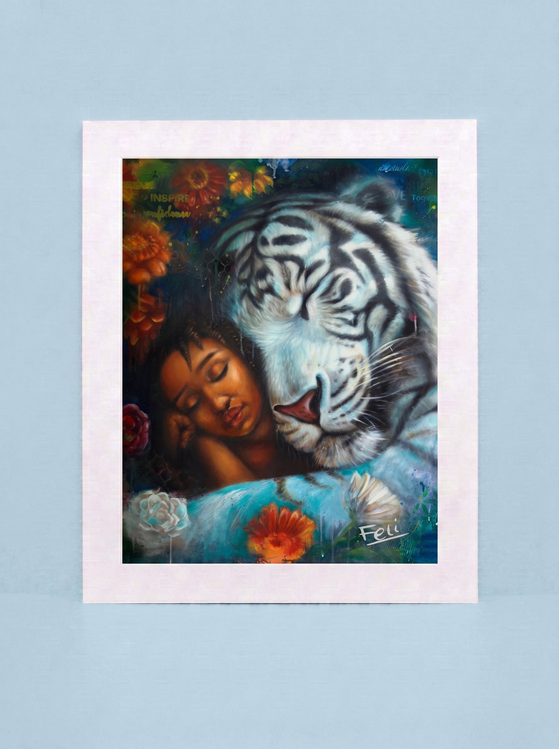 An art print entitled wild heart gentle soul by feli the artist featuring a painted scene of a white tiger and a sleeping woman surrounded by flowers, displayed against a light blue background.