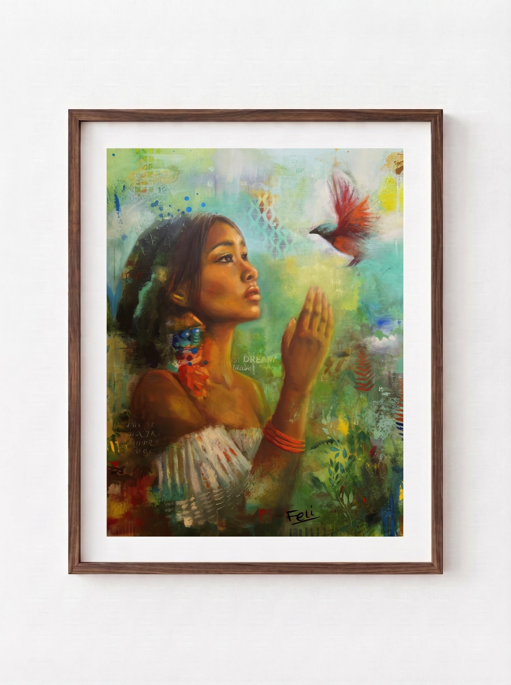 A framed art print entitled if i had wings by feli the artist hang in a dark wood frame on a white wall, depicting a indian mixed black woman reaching for a small red bird, surrounded by soft green, blue, and yellow brushstrokes.