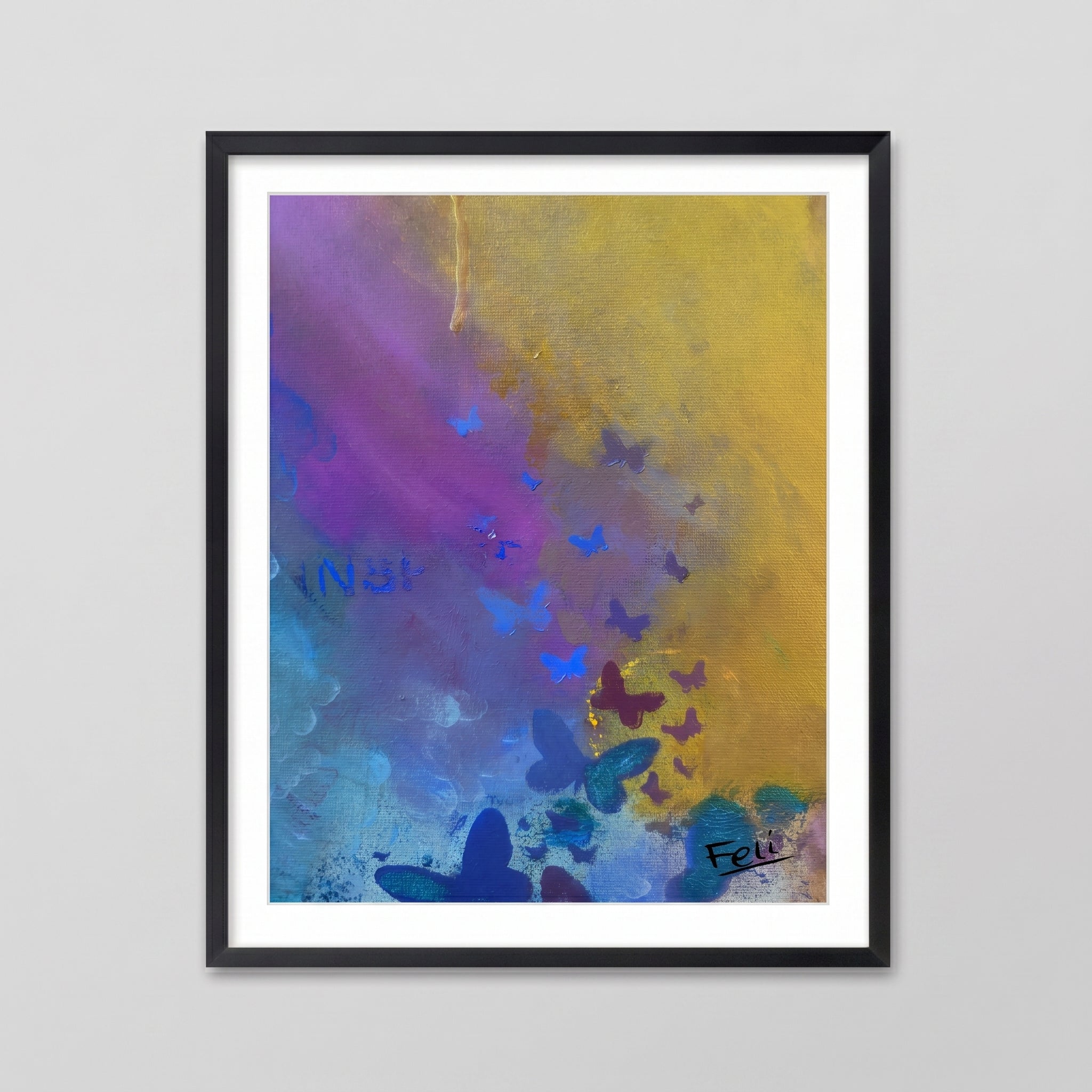 Letting go by feli the artist is a Framed abstract art print wall art featuring a colorful composition with purple, blue, yellow, and teal brushstrokes and butterfly-like shapes, hang in a black picture frame against a light gray wall.