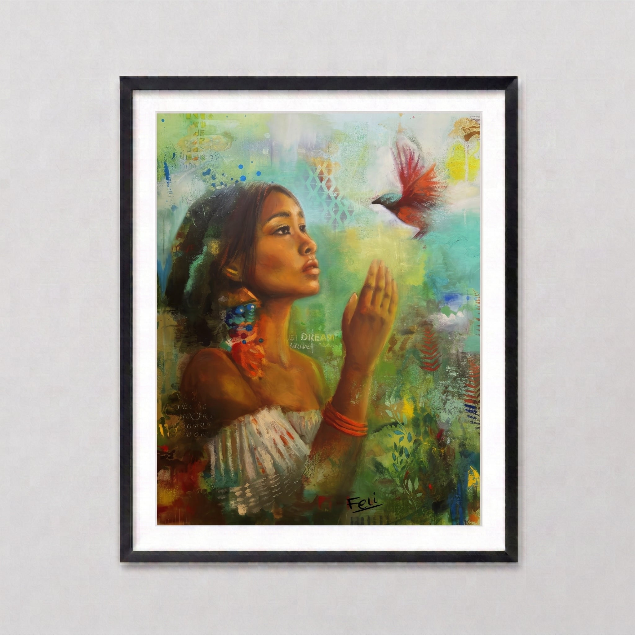 A framed art print in a black picture frame entitled if i had wings by feli the artist featuring a green colorful painting of a indian mixed black woman reaching for a red bird, set against a light gray wall background.
