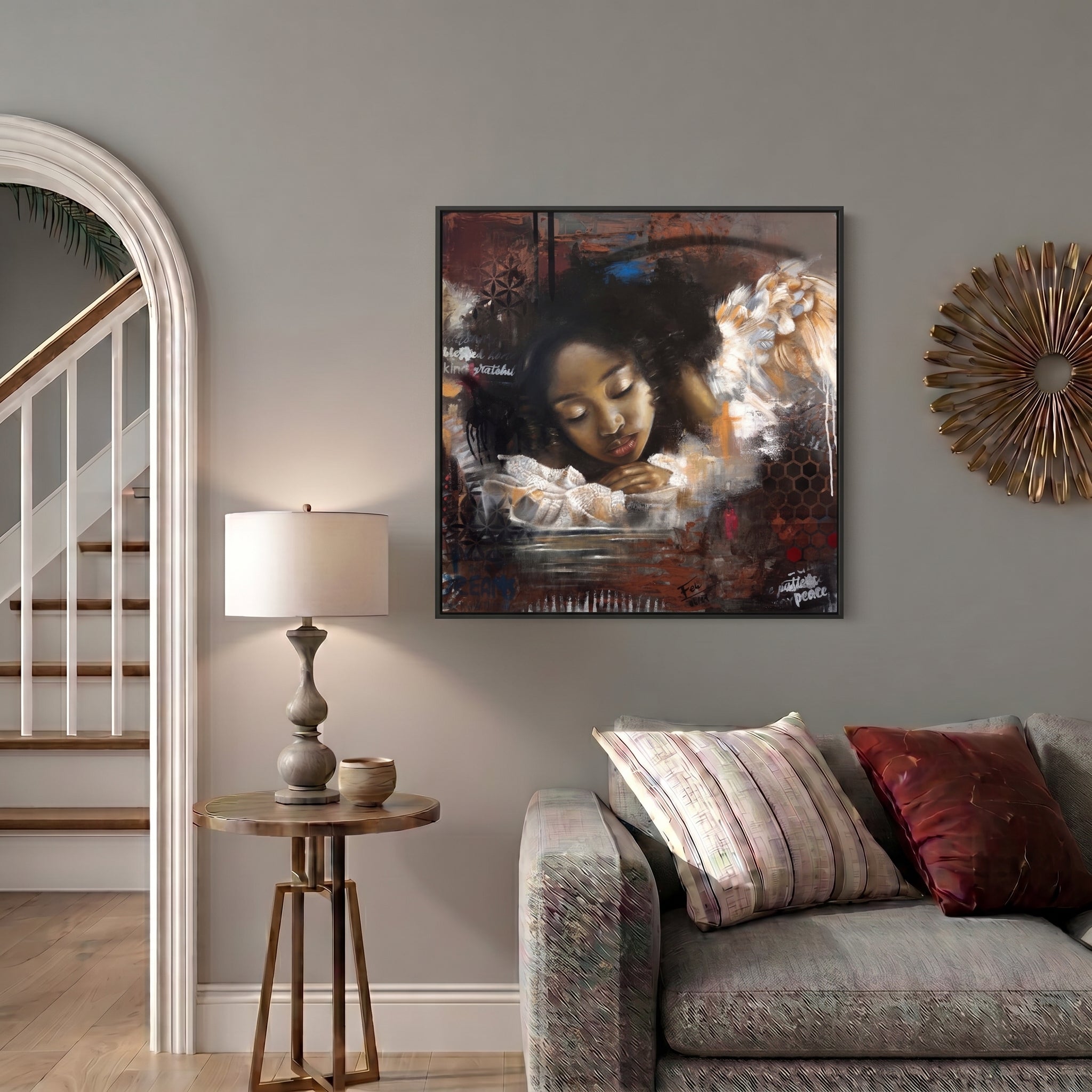 Reflections by feli the artist An expressive abstract realism framed art print hang on a livingroom wall of a young black african child with closed eyes resting on a water surface, with a large angelic figure and white wings beside them. The artwork uses dark brown, black, white, orange, and red tones with layered brushstrokes and text elements.
