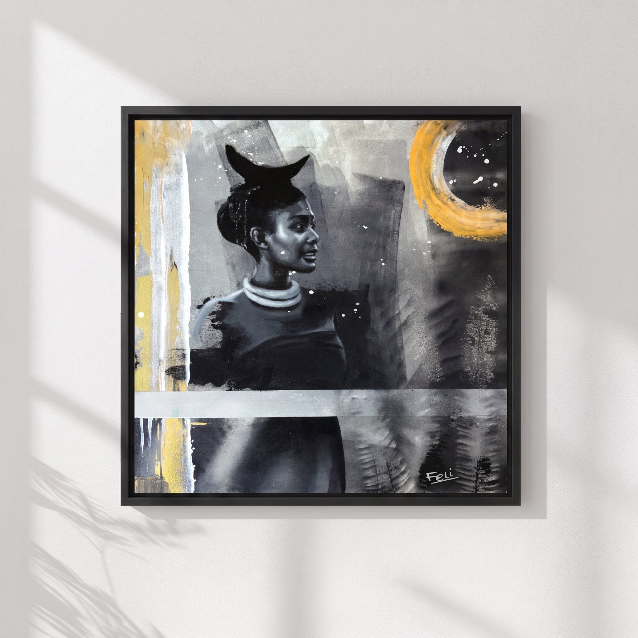 My Footsteps by Feli the artist a framed Abstract realism portrait art print of an african indian woman rendered in grayscale with bold yellow gold brushstrokes and textured splatter details hang on white wall.
