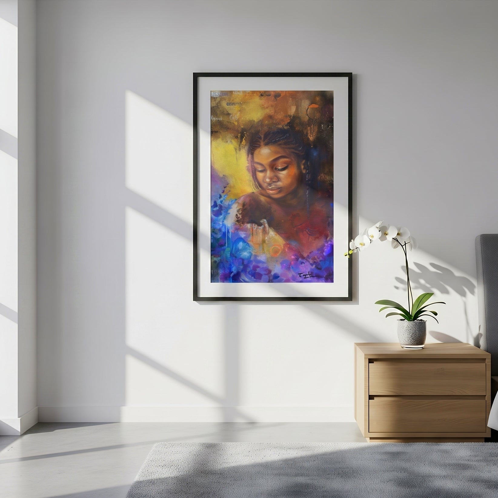 A framed vertical art print of a blue gold brown colorful art print portrait entitled as she blooms by feli the artist hangs in a black frame on a white wall in a modern bedroom setting, next to a wooden nightstand with a potted orchid.
